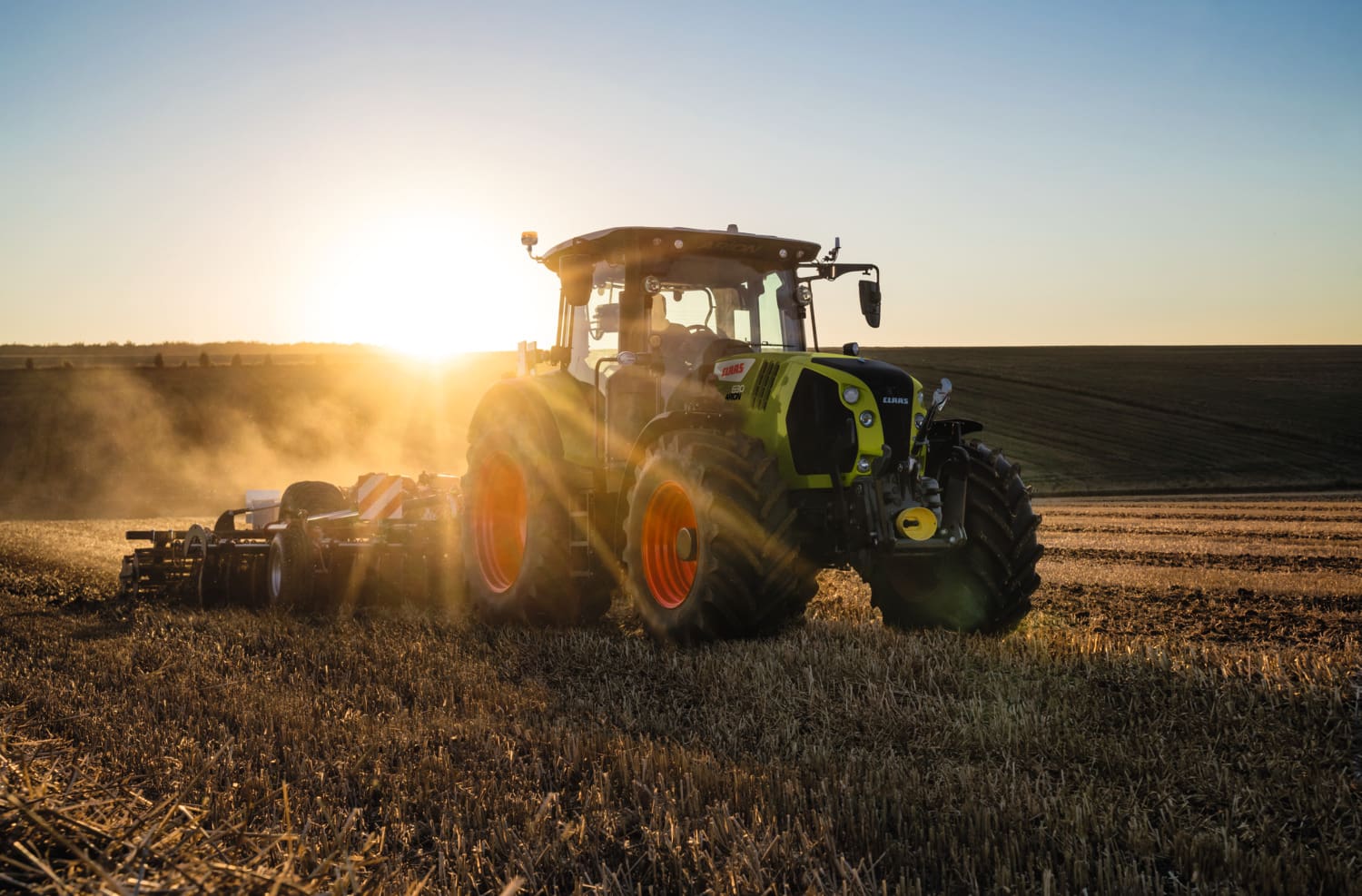 CLAAS ARION 630 Tractor driving in sunset