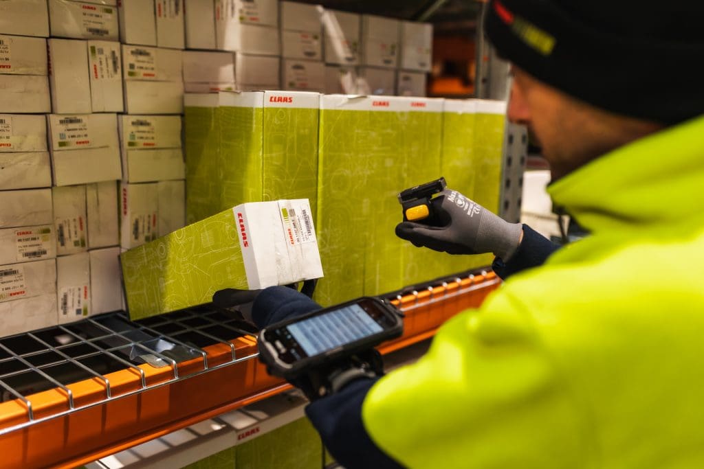 Barcode being scanned by stores person using finger scanner