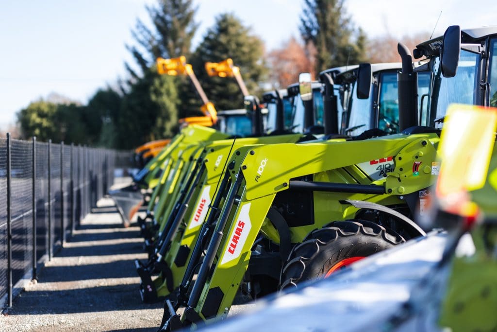 image of claas tractors lined up against a fenceline