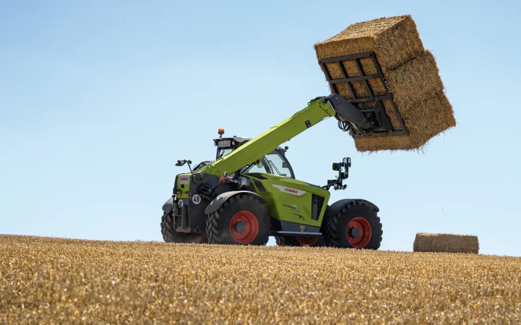 scorpion telehandler lifting bales in paddock