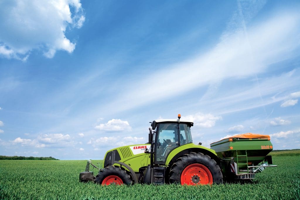 za-m spreader on the back of a claas tractor