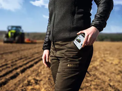 image of phone being pulled out of a pocket in the paddock