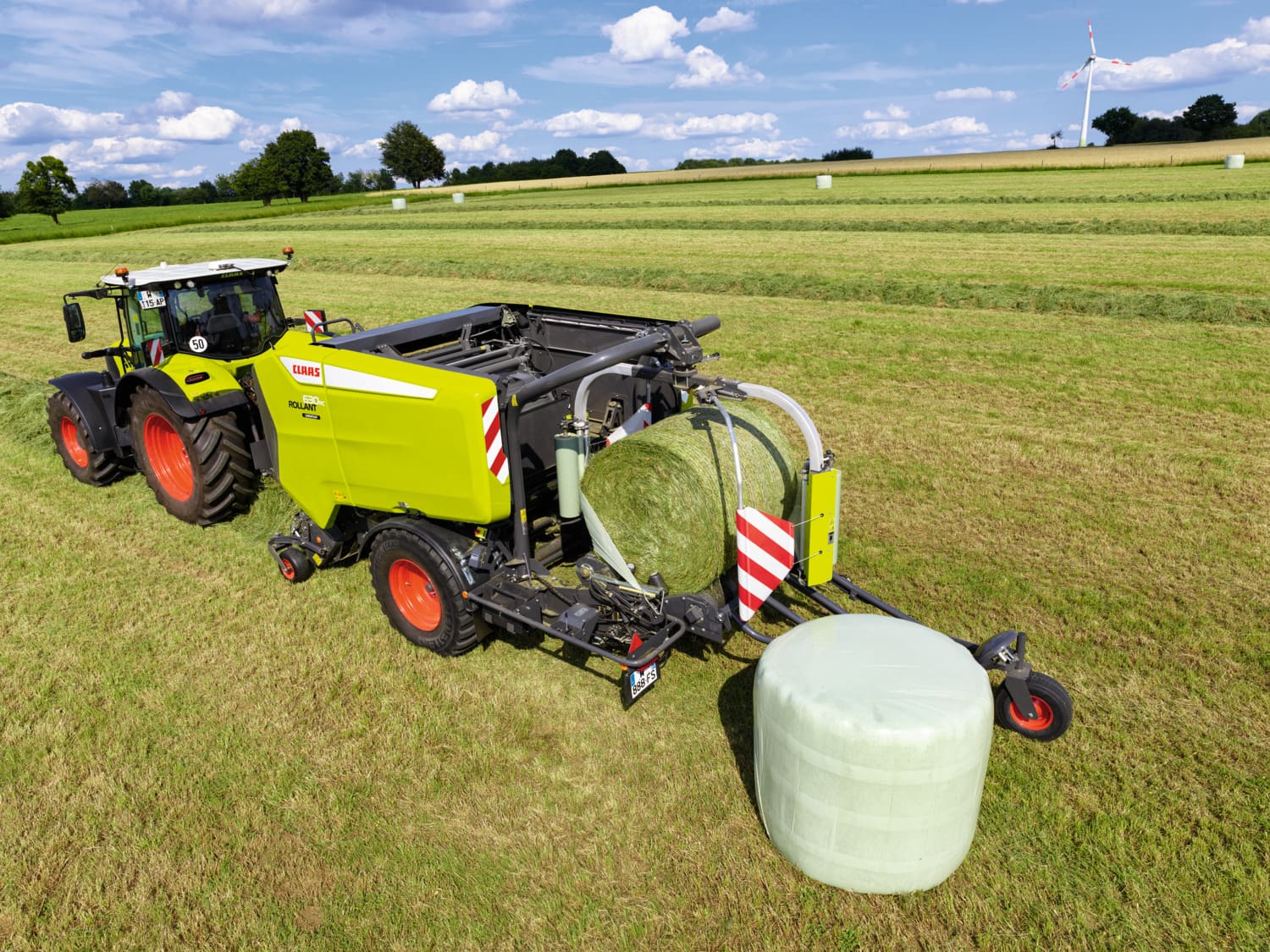 top angle image of a claas rollant baler wrapping a bale