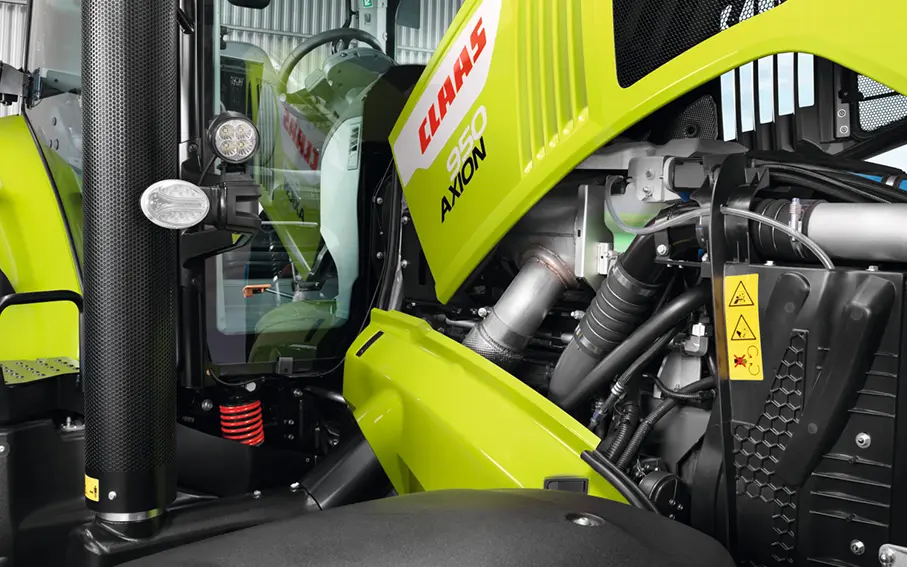 close up image of a claas axion 900 engine with bonnet popped open